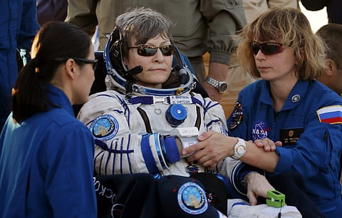 Ground personnel help U.S. astronaut Peggy Whitson after landing in a remote area outside the town of Dzhezkazgan, Kazakhstan, Sunday, Sept. 3, 2017. | AP