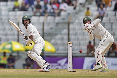 Bangladesh's Nasir Hossain, left, plays a shot, as Australia's wicketkeeper Matthew Wade follows the ball during the second day of their second test cricket match in Chittagong, Bangladesh. | AP