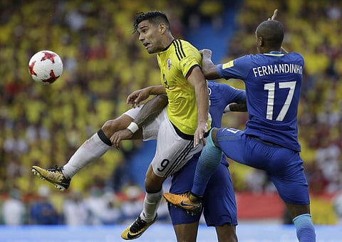 Colombia's Radamel Falcao Garcia, left, battles for the ball with Brazil's Fernandinho during a 2018 World Cup qualifying soccer match in Barranquilla. | AP