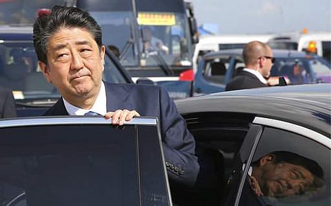 Japan's Prime Minister Shinzo Abe enters his car upon his arrival to Vladivostok, Russia. | AP