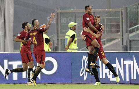 Roma's Edin Dzeko, right, celebrates with teammates after scoring during a Serie A soccer match between Roma and Inter Milan, at the Rome Olympic Stadium. | AP