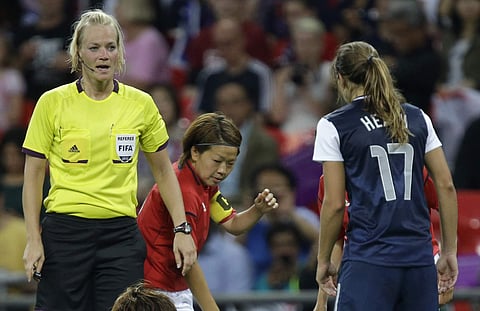 In this Thursday, Aug. 9, 2012 file photo, referee Bibiana Steinhaus from Germany, left, speaks to a Japanese player during the women's soccer gold medal match of the at the 2012 Summer Olympics. | AP