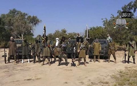 FILE - In this file image taken from video released Friday Oct. 31, 2014, by Boko Haram, Abubakar Shekau, centre, the leader of Nigeria's Islamic extremist group, surrounded by his fighters. | AP