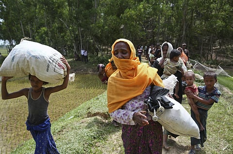 Members of Myanmar's Muslim Rohingya ethnic minority who were pushed back by Bangladeshi border guards earlier in the day rush back to the Bangladeshi side upon hearing gun shots from the Myanmar side. (File photo | AP)