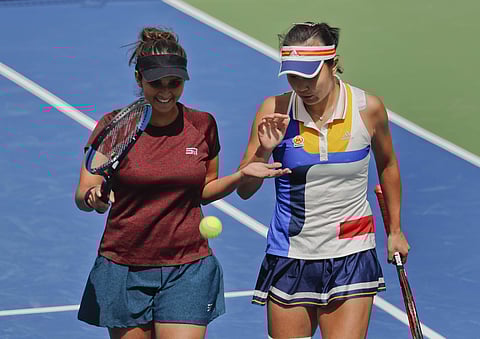 Sania Mirza, of India, left, slaps hands with doubles partner Peng Shuai, of China, during the doubles semifinals of the U.S. Open tennis tournament against Chan Yung-Jan, of Taiwan, and Martina Hingis, of Switzerland. | AP