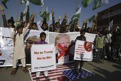 Pakistani protesters burn banners showing U.S. President Donald Trump in Hyderabad, Pakistan, Tuesday, Jan. 2, 2018. (Photo | Associated Press)