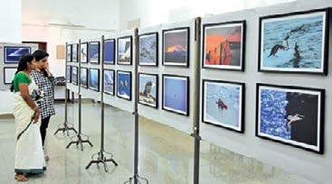 Visitors going through the pictures displayed at the ‘Indiarctica’ B P Deepu
