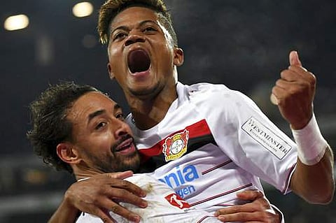Bayer Leverkusen forward Leon Bailey (top) celebrates a goal. (Photo: AP)