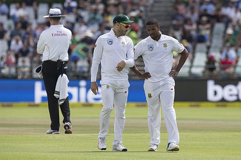 South Africa captain Faf du Plessis, left, discusses strategy with teammate Vernon Philander on the fourth day of the first test between South Africa and India at Newlands Stadium, in Cape Town. | AP