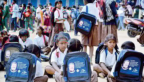 Schoolchildren wait at Police Hockey Ground opposite Garuda Mall during Shantinagar MLA N A Haris’s birthday celebration on Thursday I Pushkar V