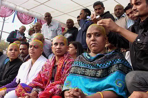 Female teachers get their heads tonsured in protest during their 'Adhikar Rally' demanding merger of their services in school education department in Bhopal on Saturday.(PTI)