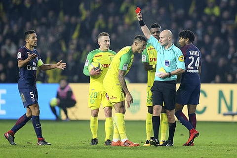 Referee Tony Chapron gives a red card to Nantes defender Diego Carlos, left, after Carlos inadvertently clipped the referee's heels (File | AP)