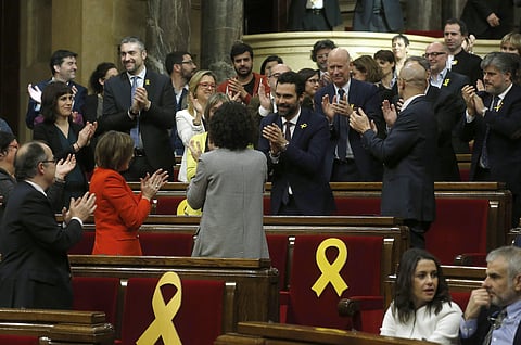 Deputy Roger Torrent, center, is congratulated after being elected as the new president of the Catalan parliament. (Photo | AP)