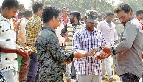 Punters bet during a cockfight at Komadavole in Eluru mandal on Tuesday | Express