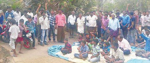People protest after a statue of BR Ambedkar was seen smeared with black paint in Guntur district on Monday