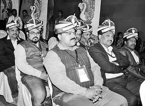 Guests wearing turbans sitting on the stage | Express