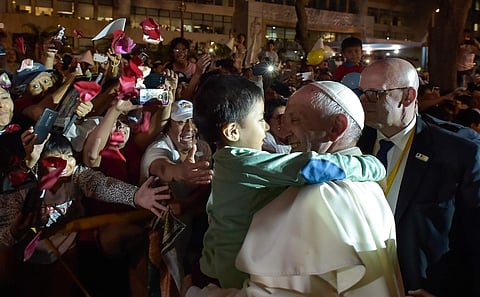 Pope Francis holds a child as he arrives to the Apostolic nunciature of the Holy See in Lima, Peru, Friday, Jan. 19, 2018. | AP