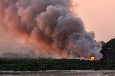 Dry grass set on fire near Bellandur lake in Bengaluru. | Express Photo.