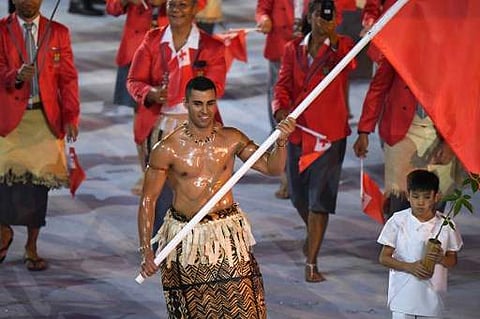 Tonga's flagbearer Pita Nikolas Taufatofua leads his delegation during the opening ceremony of the Rio 2016 Olympic Games | Photo: AFP