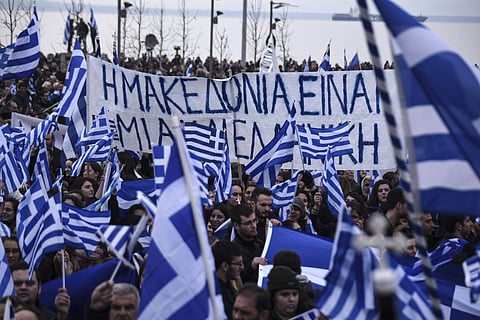 Greek protesters wave flags and a banner reading ' Macedonia is one and is Greek' | AP