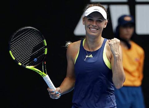 Denmark's Caroline Wozniacki celebrates after defeating Slovakia's Magdalena Rybarikova in their fourth round match at the Australian Open tennis championships in Melbourne. | Photo: AP