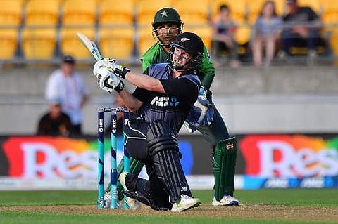 New Zealand's Colin Munro plays a shot in front of Pakistan's wicket-keeper Sarfraz Ahmed during the first Twenty20 international cricket match. | Photo: AFP
