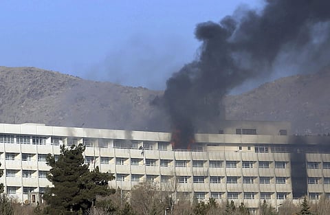 Men try to escape from a balcony of the Intercontinental Hotel after an attack in Kabul (File | AP)