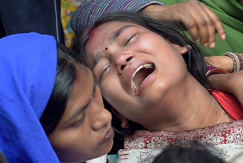 Relatives of a Bawana fire victim mourns at her house in New Delhi on Sunday. | PTI