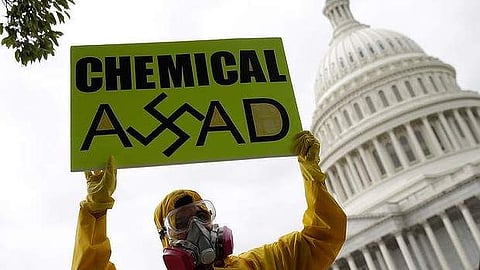Syrian-American protesters outside the US Capitol urging to strike Syria for using chemical weapons against its own people (File | AFP)