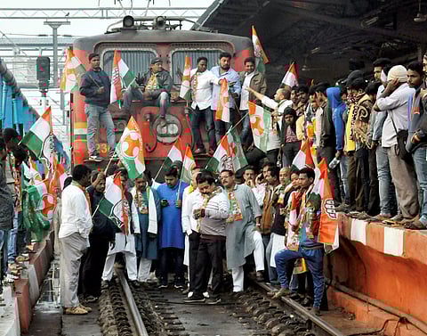Congress workers stop a train at Bhubaneswar railway station during statewide protest over the alleged suicide of Kunduli gang rape victim in Bhubaneswar on Wednesday. | PTI