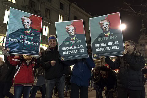 Protesters holding posters with Donald Trump's portrait saying 'You're not welcome' during the demonstration against the upcoming visit of US President Donald Trump at the World Economic Forum (WEF) in Davos, in the streets of Zurich, Switzerland, on Tues