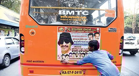 A man pasting a poster on a BMTC bus calling for a bandh on January 25 on Ballari Road in Bengaluru on Tuesday | Vinod Kumar T