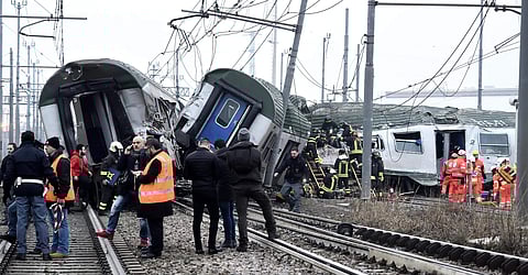 Rescue teams help passenger out of a derailed train at the station of Pioltello Limito, on the outskirts of Milan. (Photo | AP)