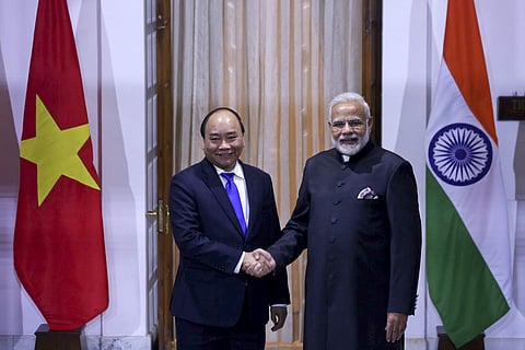 Vietnam's PM Nguyen Xuan Phuc, left, and PM Narendra Modi pose for the media ahead of their meeting in New Delhi, India. | AP