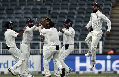 India's bowler Mohammed Shami, center, celebrates with teammates after dismissing South Africa's Aiden Markram, for 4 runs on the third day of the third cricket test match. (AP Photo/Themba Hadebe)