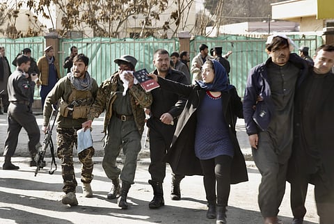 Wounded people are assisted at the site of an explosion in downtown Kabul | AP