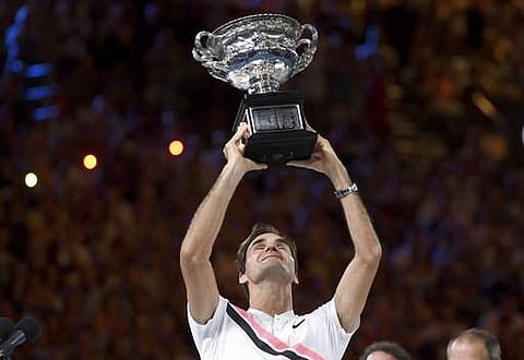 Switzerland's Roger Federer holds up his trophy after defeating Croatia's Marin Cilic in the men's singles final at the Australian Open tennis championships in Melbourne. | Photo: AP