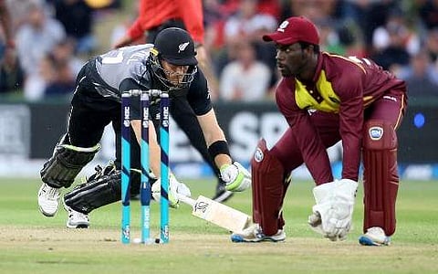 New Zealand's Martin Guptill (L) makes his ground as West Indies player Chadwick Walton (R) awaits the return during the second T20 between New Zealand and the West Indies at the Bay Oval in Mount Maunganui on January 1, 2018. | AFP
