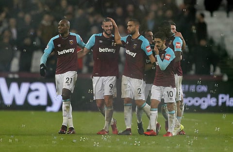 West Ham's Andy Carroll, second from left, celebrates with teammates after scoring his side's second goal during the English Premier League soccer match between West Ham and West Bromwich Albion at London Stadium. | AP