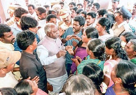 Dalits from Garagaparru in West Godavari interact with SC/ST Commission member K Ramulu at the ZP Guesthouse on Monday | Express