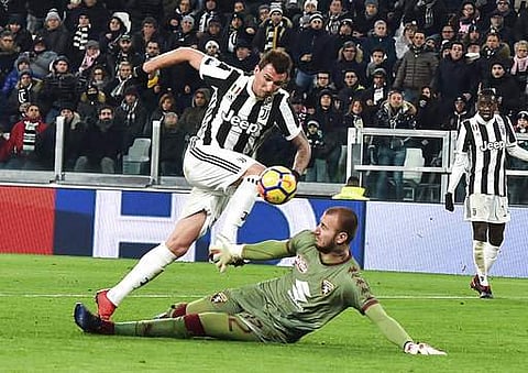 Juventus' Mario Mandzukic, top left, scores past Torino's goalkeeper Vanja Milinkovic-Savic during an Italian Cup quarter-final soccer match between Juventus and Torino at the Allianz Stadium in Turin, Italy, Wednesday, Jan. 3, 2018. (AP)