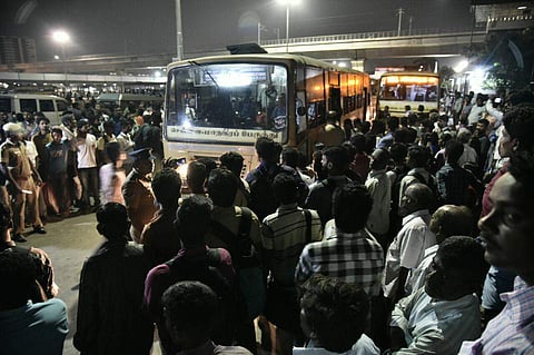 Passengers wait for buses while the staff of transport services resorted to flash strike at Koyambedu Mufisial Bus Terminus. (Photo | P Jawahar)