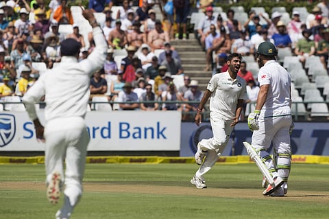 Indian fast bowler Bhuvneshwar Kumar takes the wicket of Dean Elgar of South Africa in the first over on the first day of their first day test between South Africa and India at Newlands Stadium in Cape Town. | AP