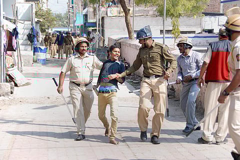 Aurangabad Police detain a miscreant during their combing operation after an incident of violent clash at Ambedkar Nagar in Aurangabad. (PTI)
