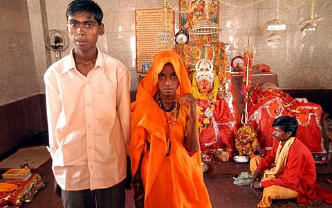 In this file photo, minors Birbal, 16, left, and Anita, 11, center, are seen after their marriage at the Jalpa Mata temple in Rajgarh, India. (File | Associated Press)