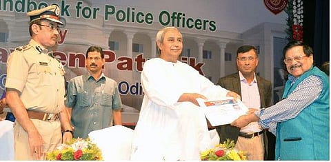 CM Naveen Patnaik presenting senior citizen ID card to former chairman of Bhubaneswar Municipal Corporation Jagannath Mohapatra on Friday | Express