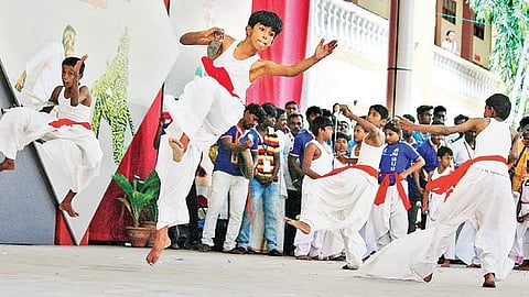 ) Participants performing Silambattam