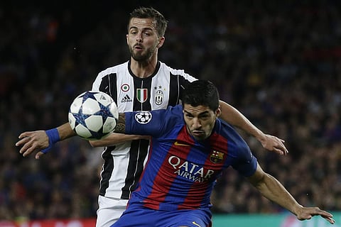 Barcelona's Luis Suarez, right, challenges Juventus's Miralem Pjanic, left in a Champions League match.| AP
