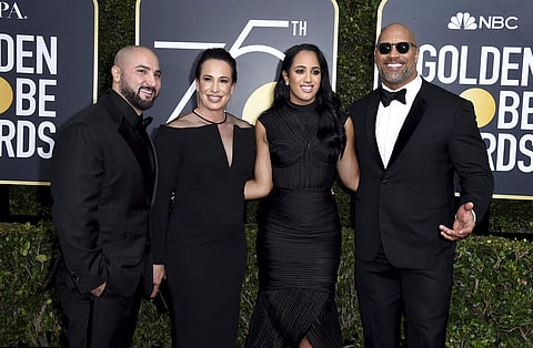 Dave Rienzi, from left, Dany Garcia, Simone Garcia Johnson and Dwayne Johnson arrive at the 75th annual Golden Globe Awards at the Beverly Hilton Hotel on Sunday. | AP