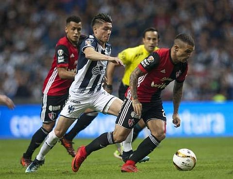 Jonathan Gonzalez (L) of Monterrey vies for the ball with Christian Tabo (R) of Atlas during their quarter final Mexican Apertura 2017 tournament football match at the BBVA Bancomer stadium in Monterrey in Mexico. (Photo: AFP)